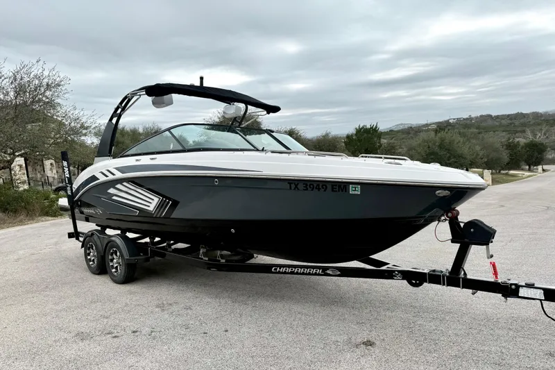 Slide: The Image of 2018 Chaparral Vortex 2430 VRX boat on trailer, parked on a road. - 13