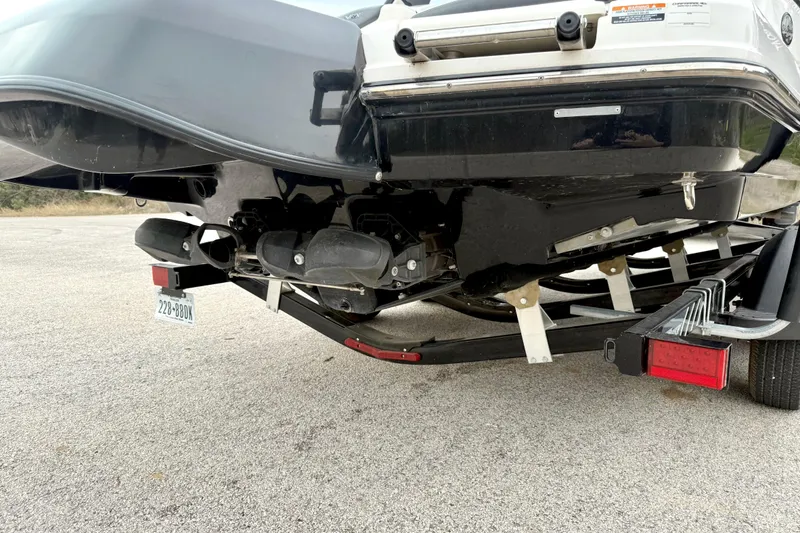 Slide: The Image of 2018 Chaparral Vortex 2430 VRX boat on trailer, rear view showing hull and license plate. - 14