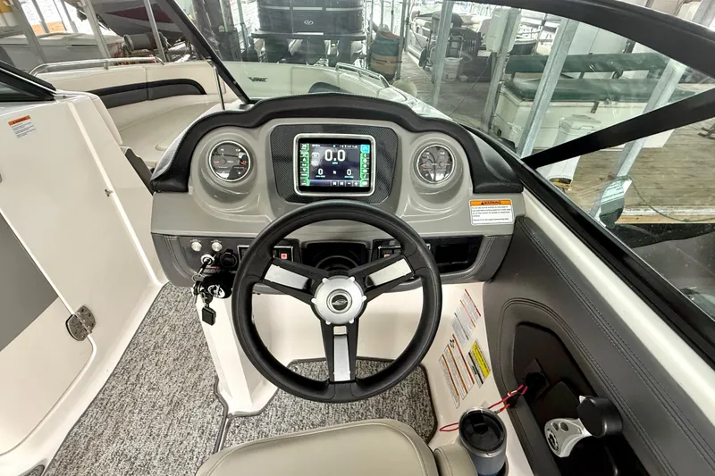 Slide: The Image of 2018 Chaparral Vortex 2430 VRX boat dashboard with steering wheel and digital display. - 23