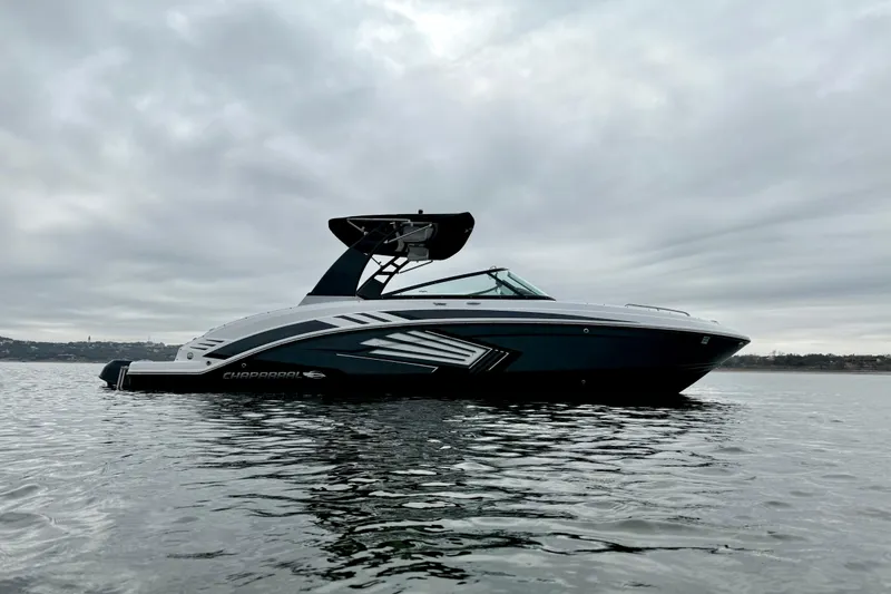 Slide: The Image of 2018 Chaparral Vortex 2430 VRX boat on calm water under cloudy sky. - 6