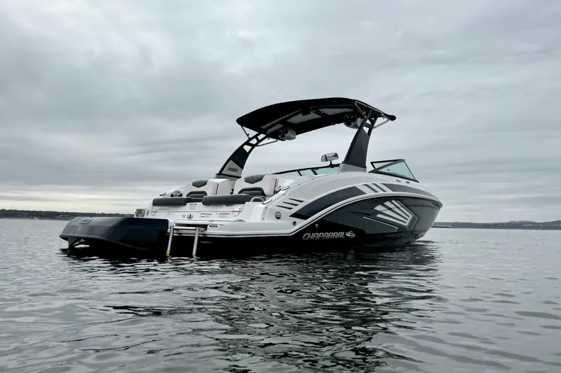 Slide: The Image of 2018 Chaparral Vortex 2430 VRX boat on calm water under cloudy sky. - 7