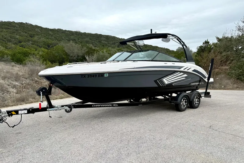 Slide: The Image of 2018 Chaparral Vortex 2430 VRX boat on trailer, parked on a scenic road. - 8