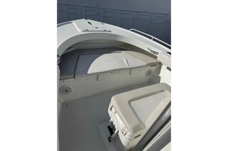 Slide: The Image of 2015 Parker 21SE Center Console boat interior with cushioned seating and storage. - 10