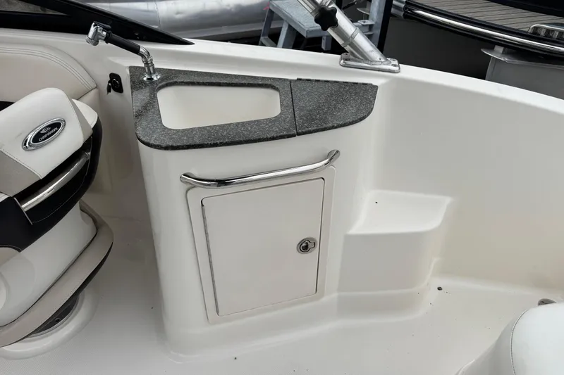 Slide: The Image of 2008 Chaparral Sunesta 224 Xtreme boat interior with sink and storage compartment. - 16