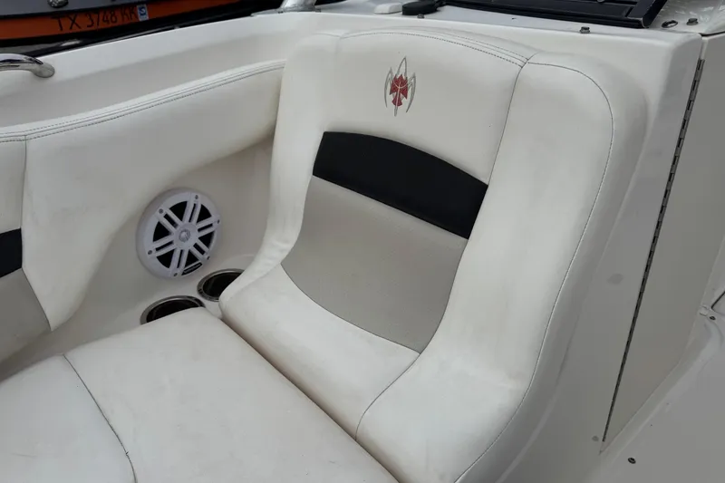 Slide: The Image of 2008 Chaparral Sunesta 224 Xtreme boat interior with white seating and speaker. - 27