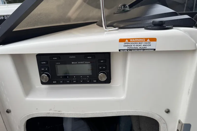 Slide: The Image of 2008 Chaparral Sunesta 224 Xtreme boat dashboard with Clarion stereo system and warning label. - 33