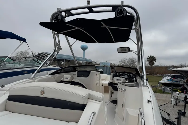 Slide: The Image of 2008 Chaparral Sunesta 224 Xtreme boat interior with seating and canopy, parked outdoors. - 8