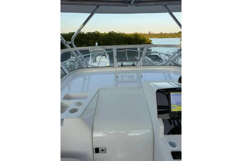 Slide: The Image of 2007 Pro-Line 32 Express boat helm with navigation system, docked by scenic waterway. - 10
