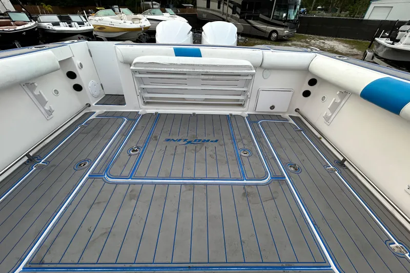 Slide: The Image of 2007 Pro-Line 32 Express boat deck with blue accents, showcasing spacious layout and seating. - 101