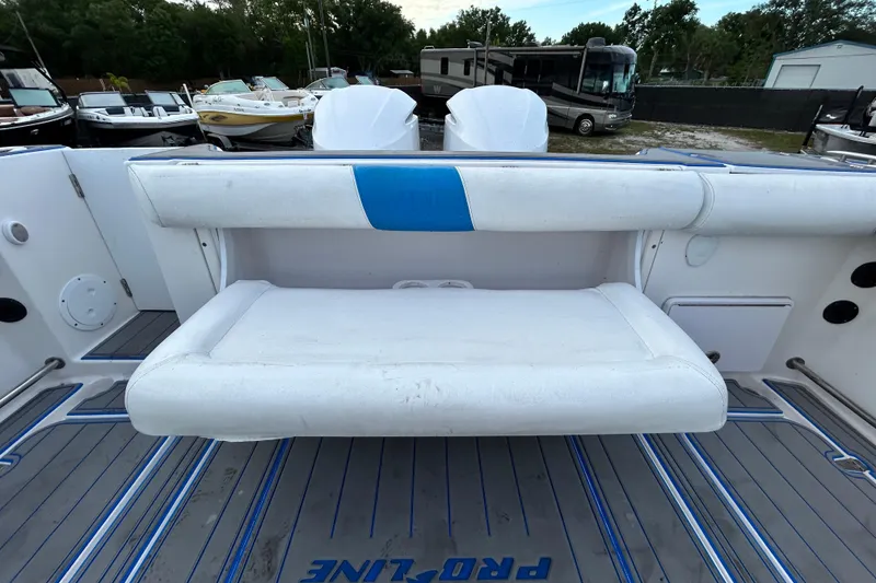 Slide: The Image of 2007 Pro-Line 32 Express boat interior with white seating and blue accents. - 104