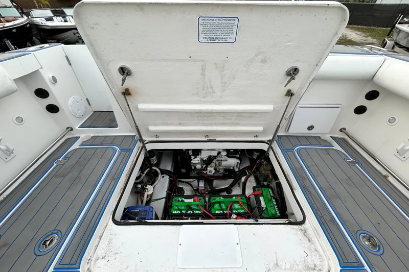 Slide: The Image of Open engine compartment of 2007 Pro-Line 32 Express boat, showing batteries and wiring. - 105