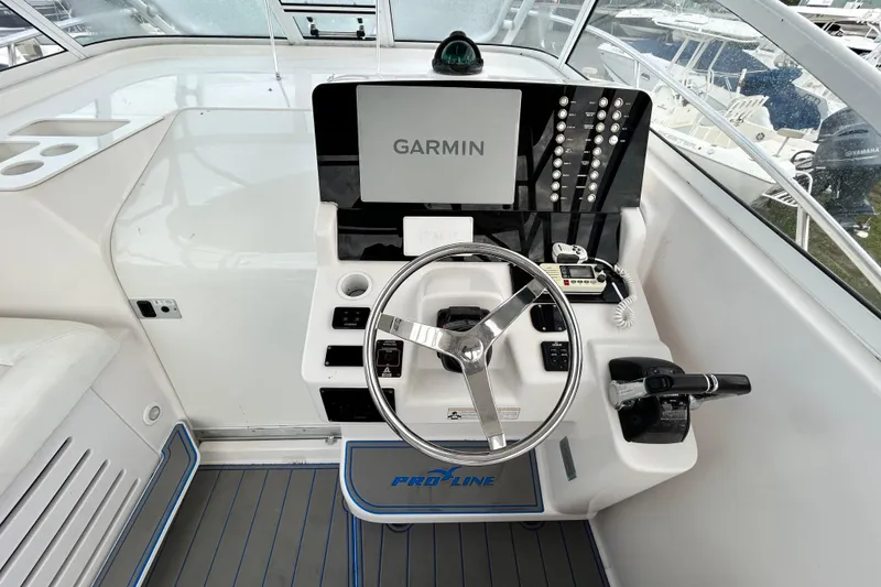 Slide: The Image of 2007 Pro-Line 32 Express helm with Garmin navigation, steering wheel, and control panel. - 109
