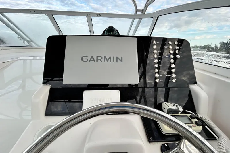 Slide: The Image of 2007 Pro-Line 32 Express boat helm with Garmin navigation system and control panel. - 111