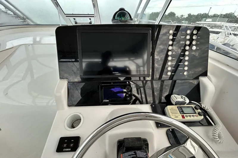Slide: The Image of Helm of 2007 Pro-Line 32 Express boat with Garmin display and controls. - 112