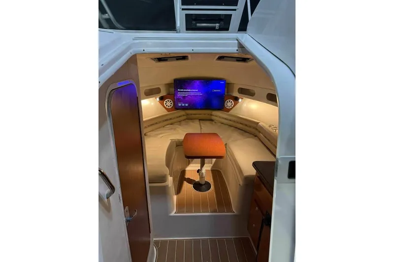 Slide: The Image of 2007 Pro-Line 32 Express cabin interior with cozy seating and mounted TV. - 14