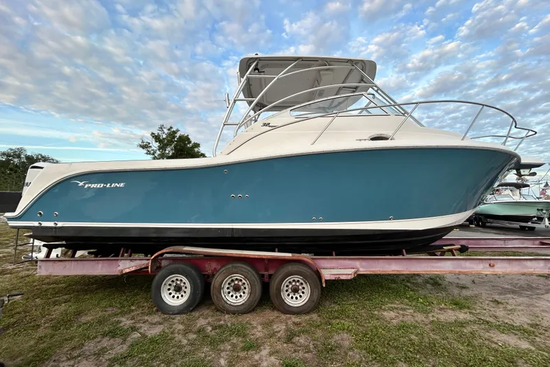 Slide: The Image of 2007 Pro-Line 32 Express boat on trailer under cloudy sky. - 17