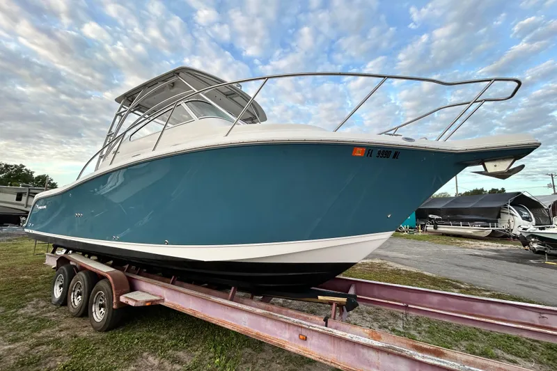 Slide: The Image of 2007 Pro-Line 32 Express boat on trailer under cloudy sky. - 18