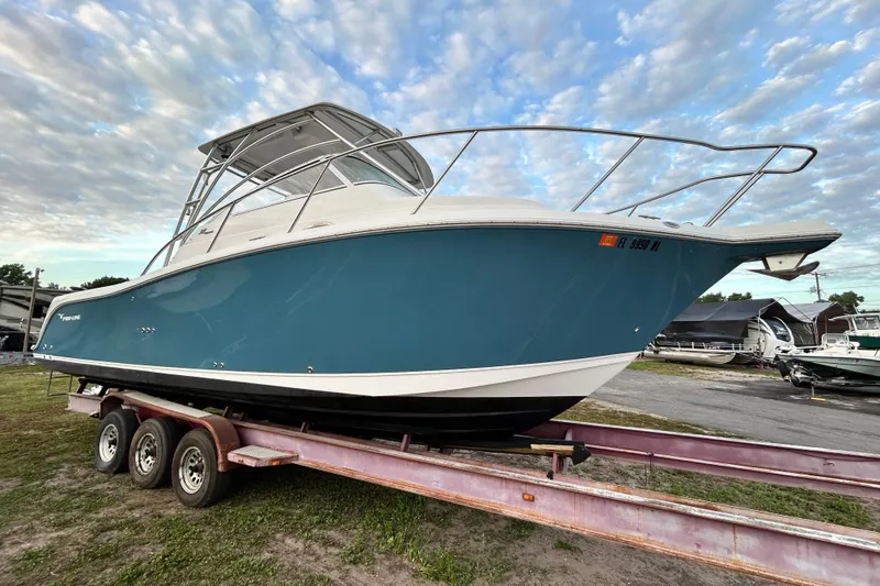 Slide: The Image of 2007 Pro-Line 32 Express boat on trailer under a cloudy sky. - 19