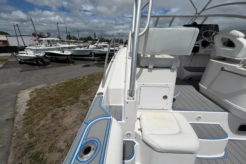 Slide: The Image of 2007 Pro-Line 32 Express boat interior with seating, docked among other boats. - 22