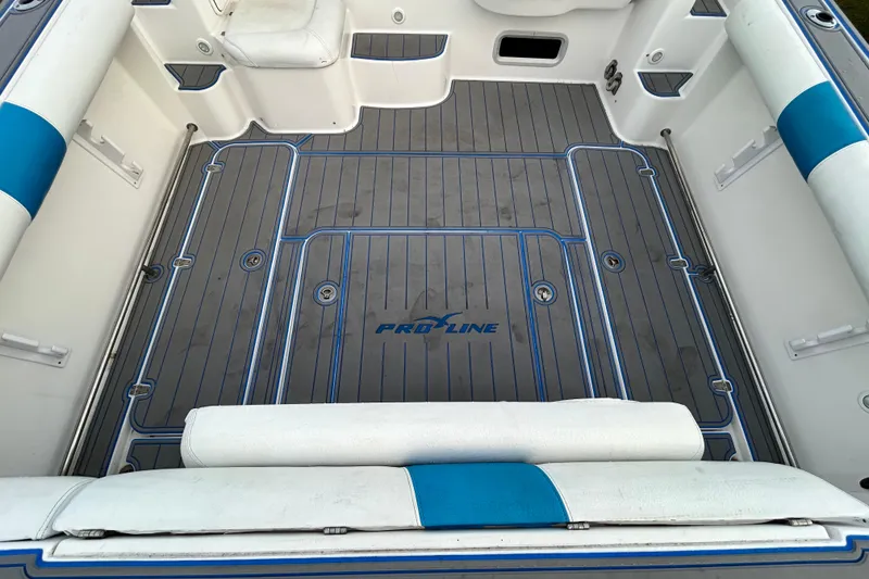 Slide: The Image of 2007 Pro-Line 32 Express boat interior with blue and white seating and deck. - 25