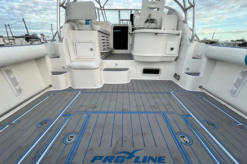 Slide: The Image of 2007 Pro-Line 32 Express boat deck with seating and storage, featuring sleek design and spacious layout. - 27