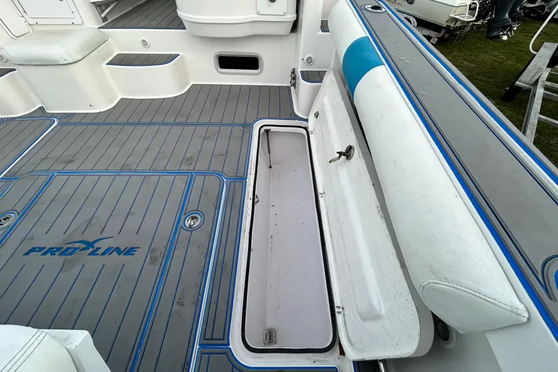 Slide: The Image of 2007 Pro-Line 32 Express boat interior with open storage compartment and cushioned seating. - 29