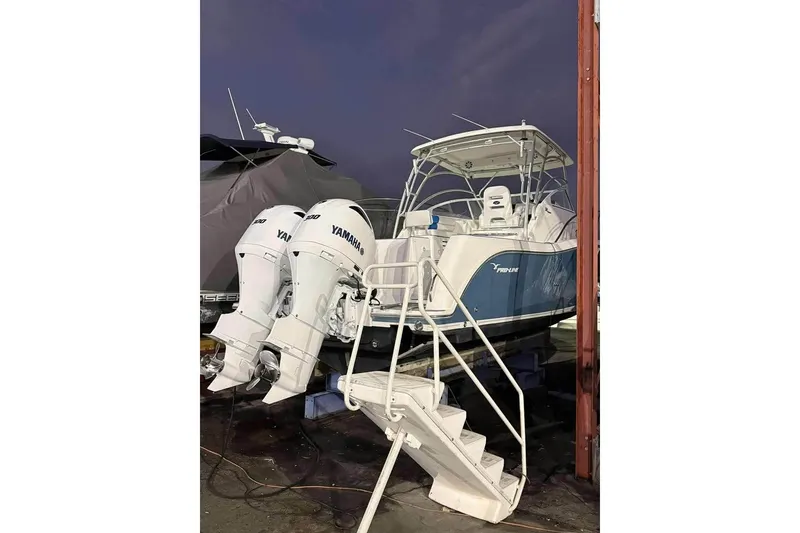 Slide: The Image of 2007 Pro-Line 32 Express boat with twin Yamaha engines, docked at night. - 3