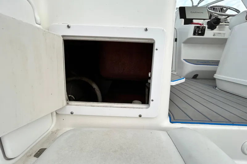 Slide: The Image of 2007 Pro-Line 32 Express boat interior with open storage compartment and visible helm. - 36