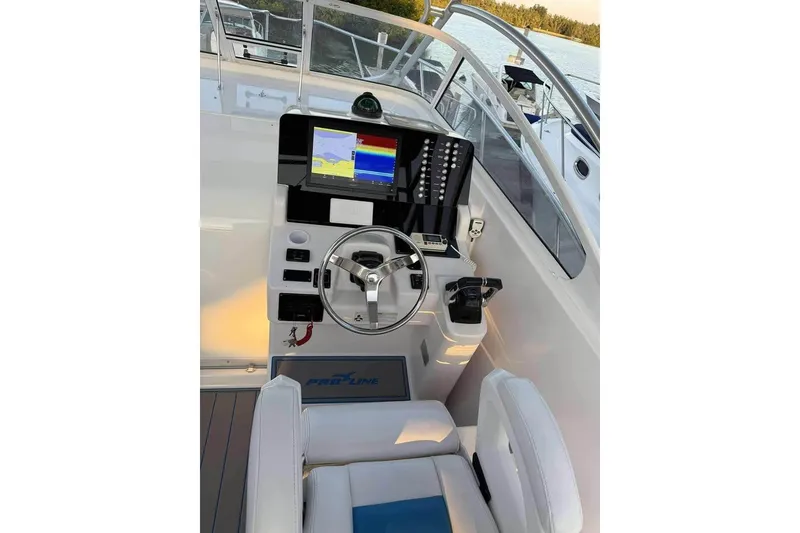 Slide: The Image of 2007 Pro-Line 32 Express boat helm with navigation display and steering wheel. - 4