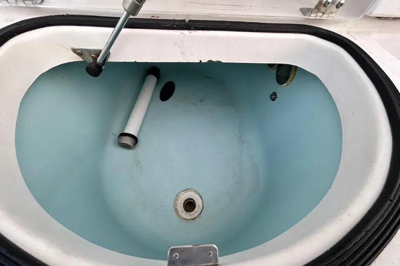 Slide: The Image of Livewell interior of 2007 Pro-Line 32 Express boat, featuring drain and fittings. - 42