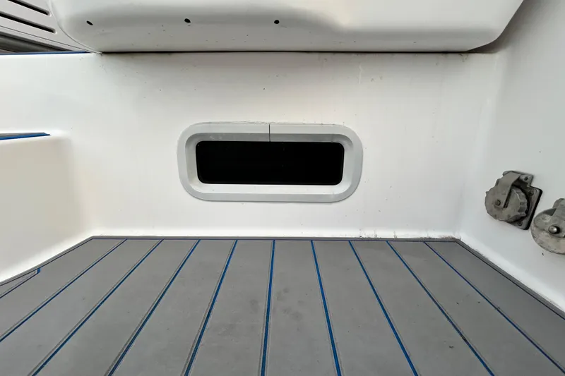 Slide: The Image of 2007 Pro-Line 32 Express boat interior with gray and blue striped flooring. - 44