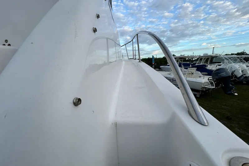Slide: The Image of 2007 Pro-Line 32 Express boat deck with stainless steel railing under a cloudy sky. - 47