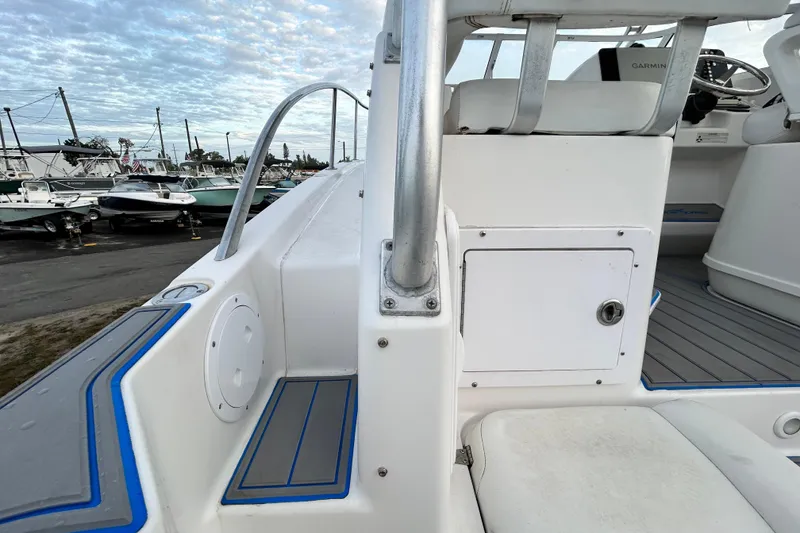 Slide: The Image of 2007 Pro-Line 32 Express boat interior with seating and storage, docked near other boats. - 50