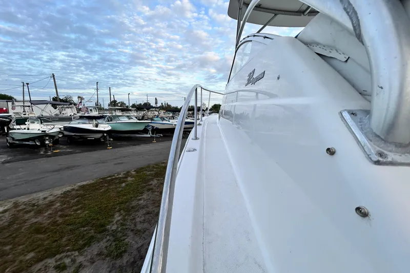 Slide: The Image of 2007 Pro-Line 32 Express boat docked, surrounded by other boats under a cloudy sky. - 52