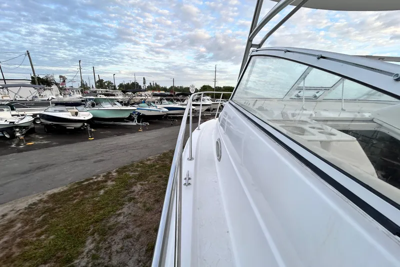 Slide: The Image of 2007 Pro-Line 32 Express boat in a marina with other vessels under a cloudy sky. - 54