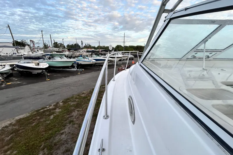 Slide: The Image of 2007 Pro-Line 32 Express boat docked, surrounded by other boats under a cloudy sky. - 55