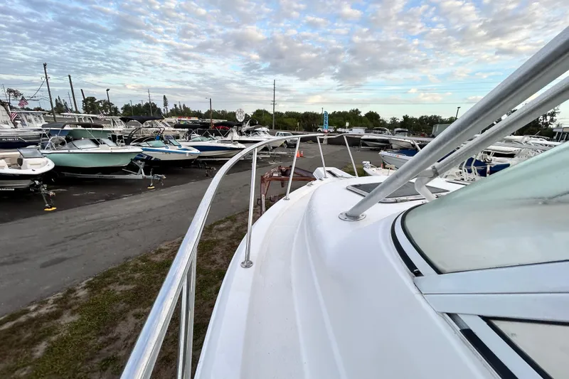 Slide: The Image of 2007 Pro-Line 32 Express boat in a marina with other vessels under a cloudy sky. - 56