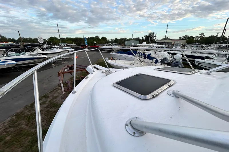 Slide: The Image of 2007 Pro-Line 32 Express boat on display in a marina with other vessels. - 57