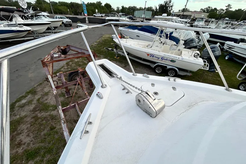 Slide: The Image of 2007 Pro-Line 32 Express boat deck view in a marina with surrounding boats. - 59
