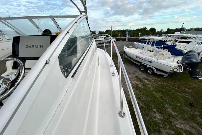 Slide: The Image of 2007 Pro-Line 32 Express boat with Garmin navigation, docked near other boats under a cloudy sky. - 61