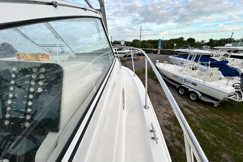 Slide: The Image of 2007 Pro-Line 32 Express boat docked, showcasing sleek design and control panel. - 62