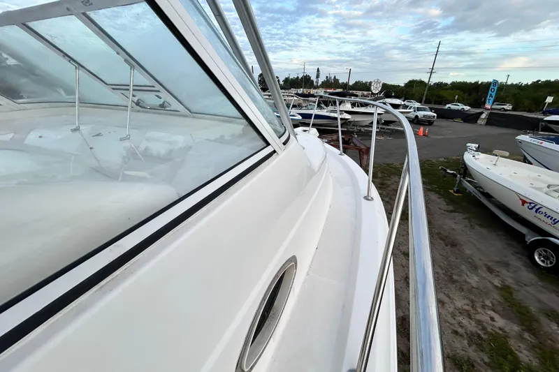 Slide: The Image of 2007 Pro-Line 32 Express boat docked, showcasing sleek design and spacious deck. - 63