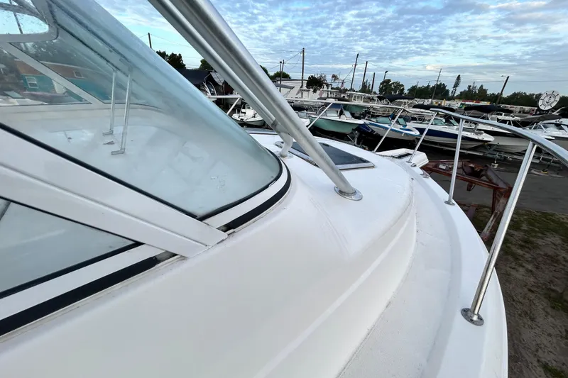 Slide: The Image of 2007 Pro-Line 32 Express boat deck with railing, docked among other boats. - 64