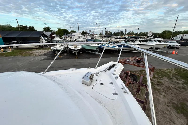 Slide: The Image of 2007 Pro-Line 32 Express boat in a marina with other vessels under a cloudy sky. - 66