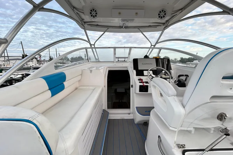 Slide: The Image of 2007 Pro-Line 32 Express boat interior with helm, seating, and Garmin navigation system. - 67