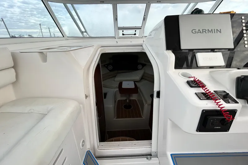 Slide: The Image of 2007 Pro-Line 32 Express boat interior with Garmin navigation system and cozy cabin entrance. - 69