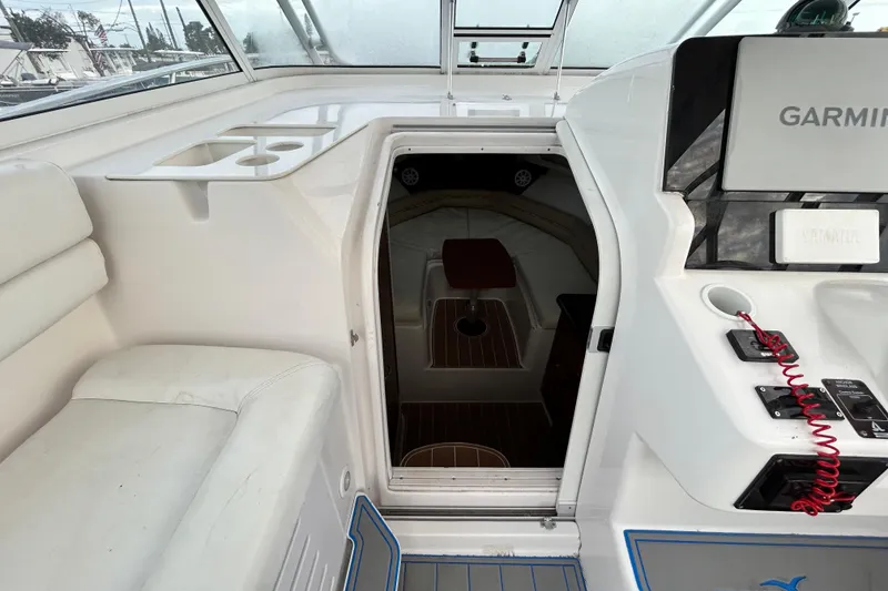 Slide: The Image of 2007 Pro-Line 32 Express boat interior with seating, navigation equipment, and cabin entrance. - 72