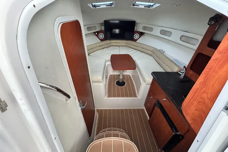 Slide: The Image of 2007 Pro-Line 32 Express cabin interior with seating, table, and kitchenette. - 73