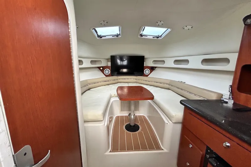 Slide: The Image of 2007 Pro-Line 32 Express cabin interior with seating, table, and TV. - 74