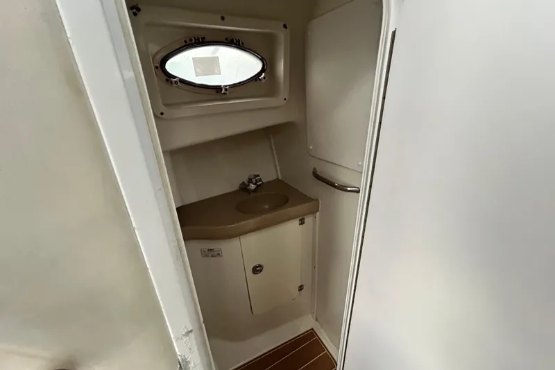 Slide: The Image of 2007 Pro-Line 32 Express boat bathroom with sink and porthole window. - 75